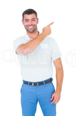 Smiling male technician pointing at copy space on white backgrou