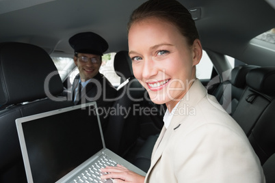 Businesswoman being chauffeured while working