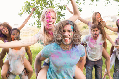 Happy friends covered in powder paint