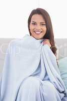 Beautiful woman wrapped with blanket