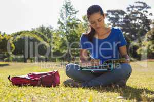 Pretty student studying outside