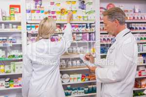 Pharmacist holding writing on clipboard