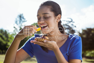 Pretty woman eating pizza in the park