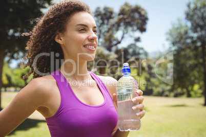 Fit woman holding bottle of water