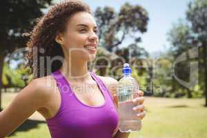 Fit woman holding bottle of water
