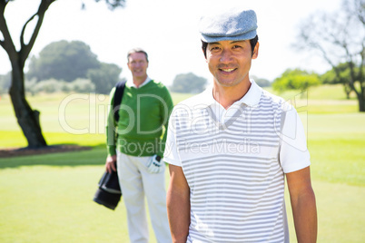 Golfing friends smiling at camera