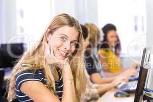 Student smiling at camera in computer class