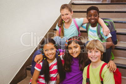 School kids sitting on stairs in school