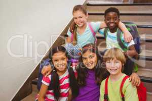 School kids sitting on stairs in school