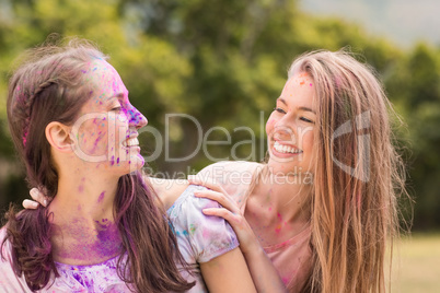 Happy friends covered in powder paint