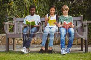 Children reading books at park