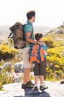 Father and son hiking through mountains