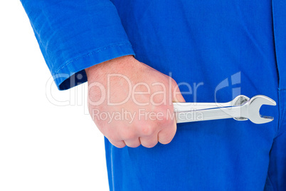Mechanic holding spanners on white background