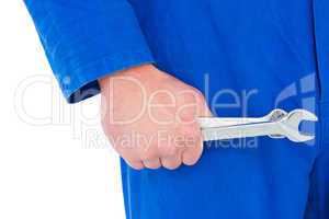 Mechanic holding spanners on white background