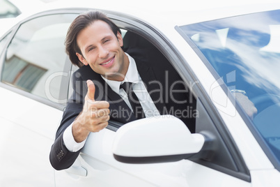 Smiling businessman with thumb up