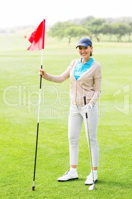 Female golfer smiling at camera