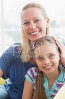 Loving mother with daughter in living room