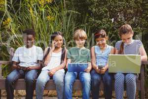 Children using technologies at park