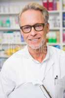 Senior pharmacist holding a clipboard