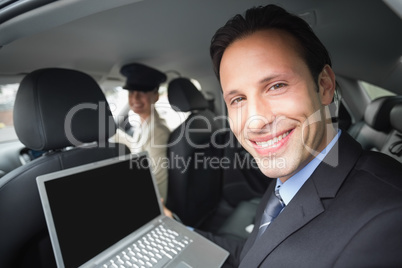 Businesswoman being chauffeured while working