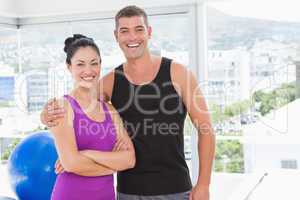 Fit couple smiling at camera