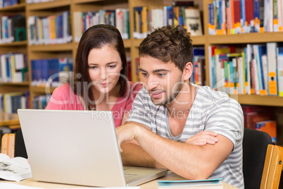 College students using laptop in library