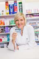 Smiling pharmacist holding credit card