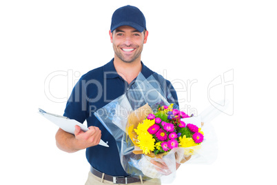 Happy flower delivery man holding clipboard