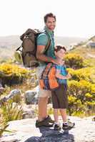 Father and son hiking through mountains