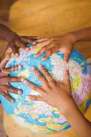 Close up of hands on globe