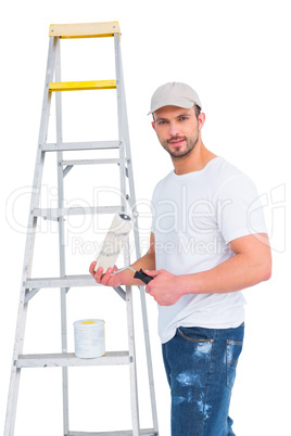 handyman with paint roller and ladder