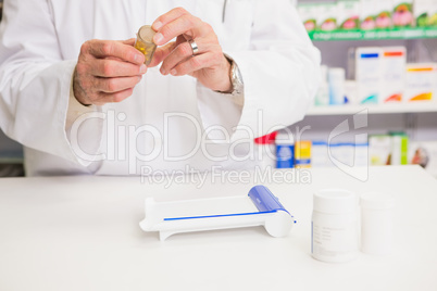 Pharmacist holding jar of medicine