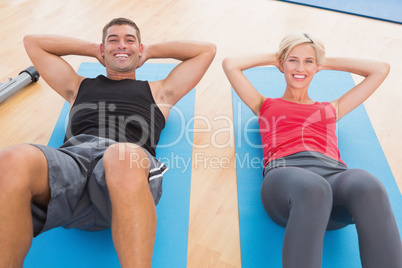 Happy fit couple working on exercise mat