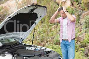 Stressed man looking at engine