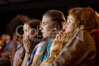 Young friends watching a film