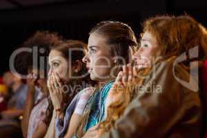 Young friends watching a film