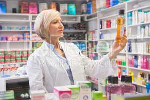 Cheerful pharmacist holding medication