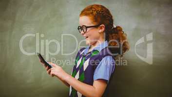 Side view of cute little girl holding calculator