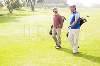 Golfer friends walking and chatting