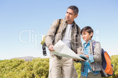 Father and son hiking in the mountains on a sunny day