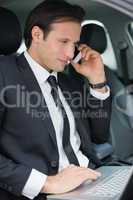 Businessman working in the drivers seat