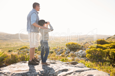 Father and son hiking through mountains