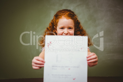 Portrait of cute little girl holding paper