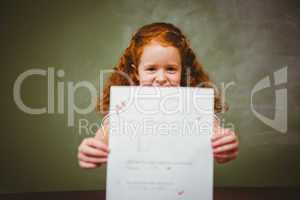 Portrait of cute little girl holding paper