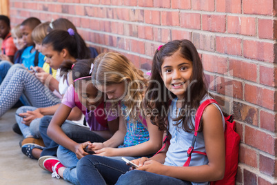 Cute pupils using mobile phone