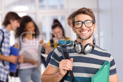 Male student holding folder in college