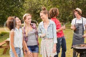 Happy friends in the park having barbecue