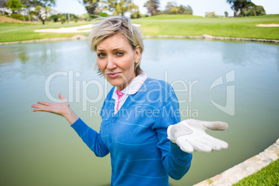 Confused female golfer looking at lake