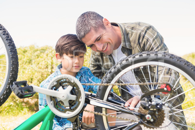 Father and son repairing bike