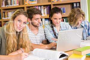 College students doing homework in library